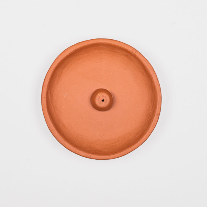 A round incense holder made of clay.