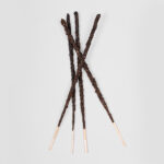Four Sagrada Madre incense sticks which are rolled by hand and look dark.