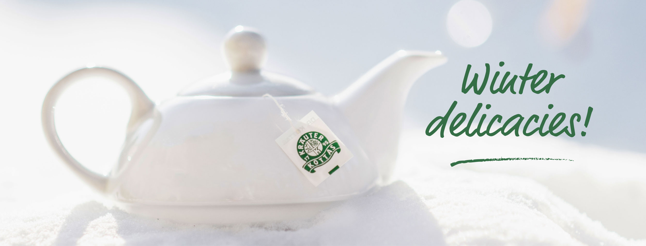 White porcelain teapot in the snow.