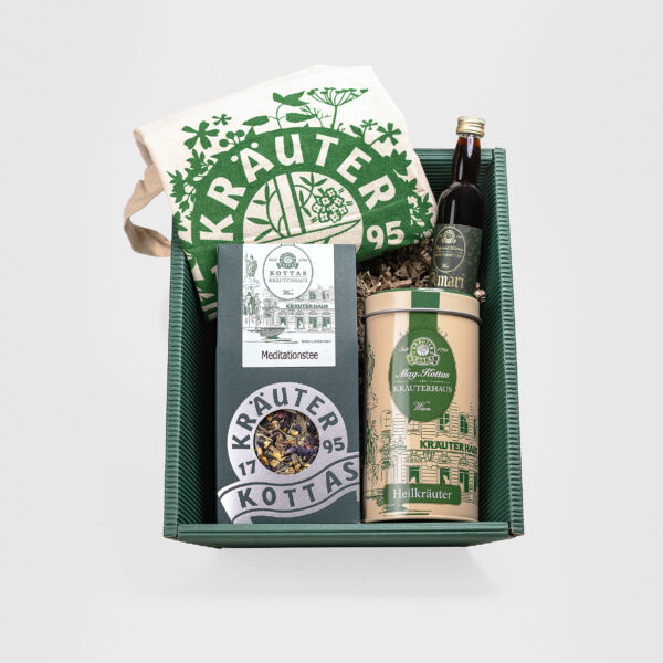 Dark green cardboard box with meditation herbal tea, metal tea caddy, Amari herbal bitters and cotton cloth bag printed with KOTTAS herbal logo